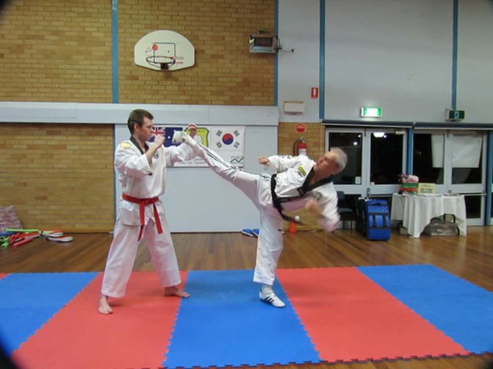 Adults practicing high kicks at taekwondo martial arts in Tamworth